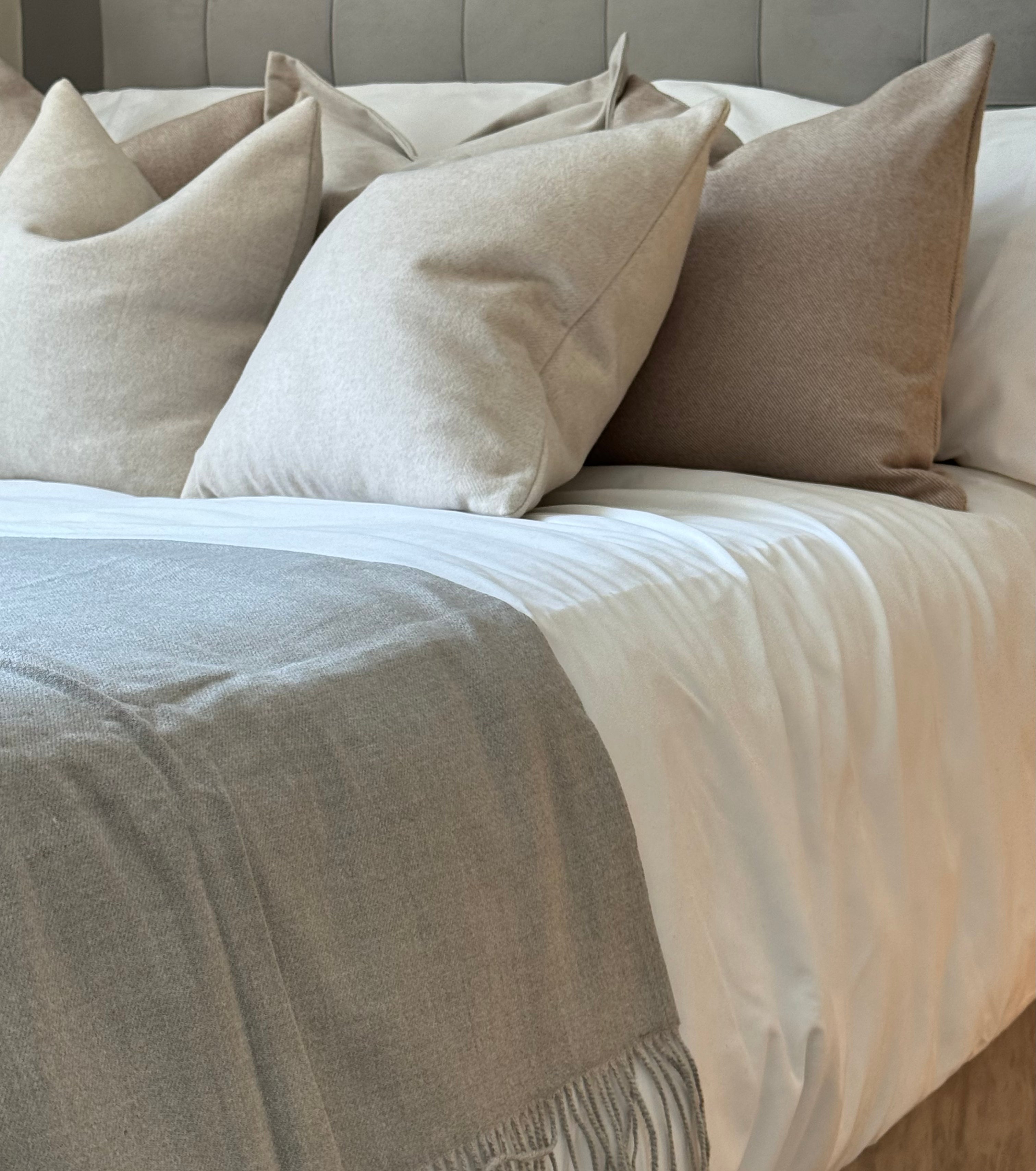 Bed styled with Mysa Homeware's neutral luxury cushions and bed runner, creating a neutral aesthetic, cosy bedroom ambiance.