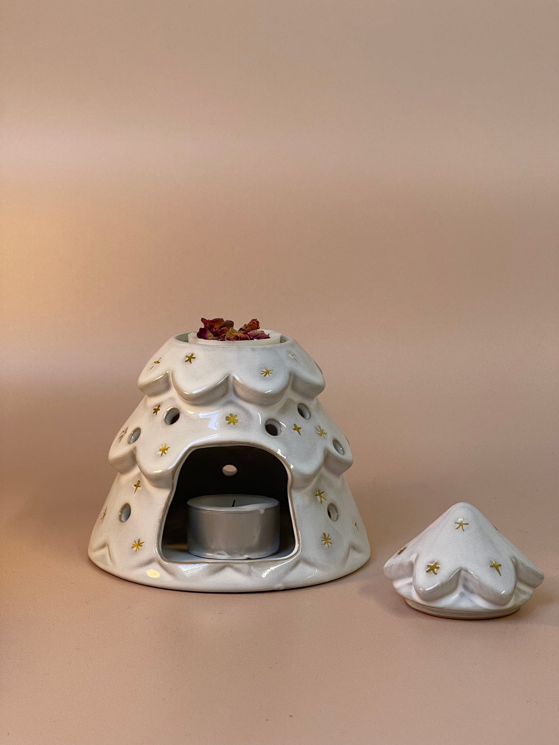 Christmas tree-shaped wax melt burner adorned with festive details, ideal for melting wax melts and spreading delightful holiday fragrances throughout your home.