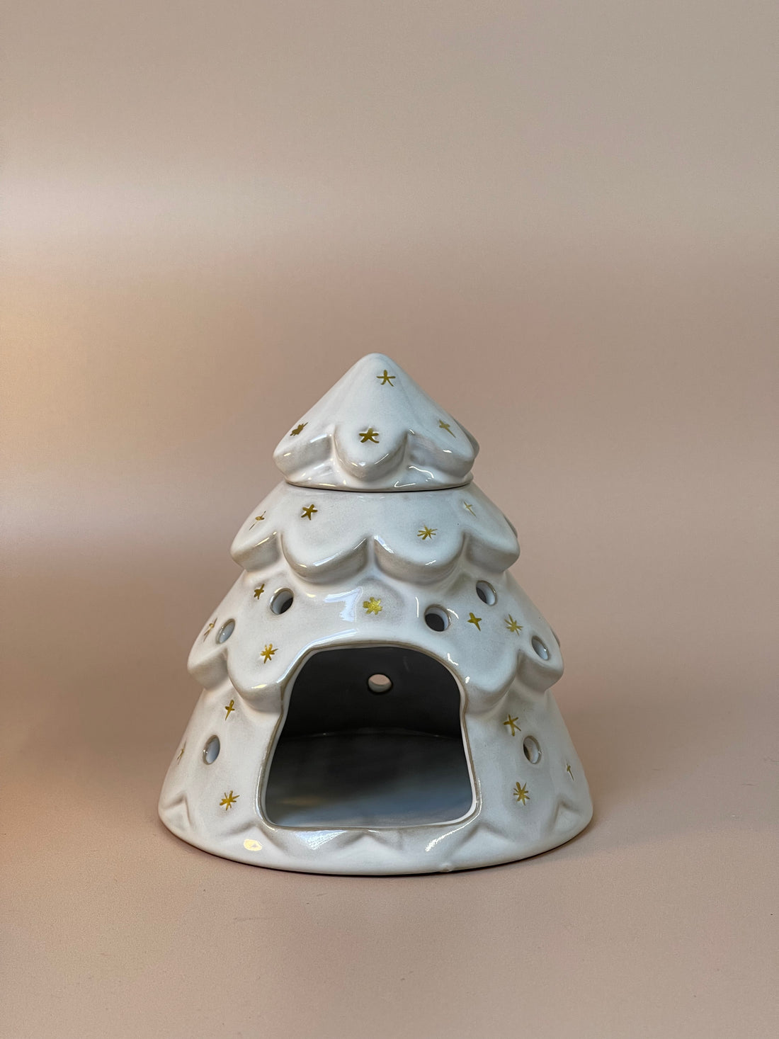 Christmas tree-shaped wax melt burner adorned with festive details, ideal for melting wax melts and spreading delightful holiday fragrances throughout your home.