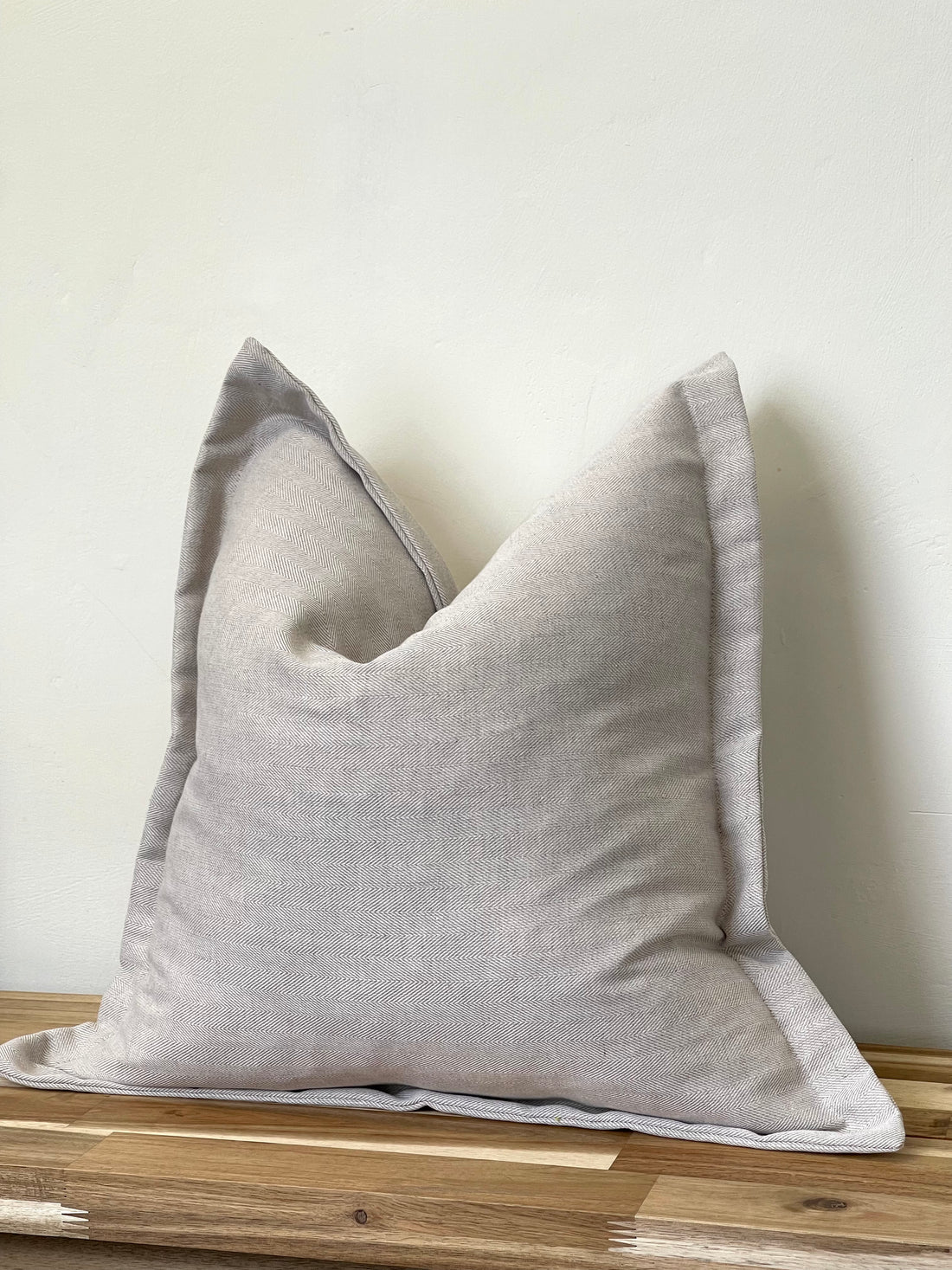Luxury linen blend cushion in a neutral color, designed to complement and enhance a neutral aesthetic in home decor.